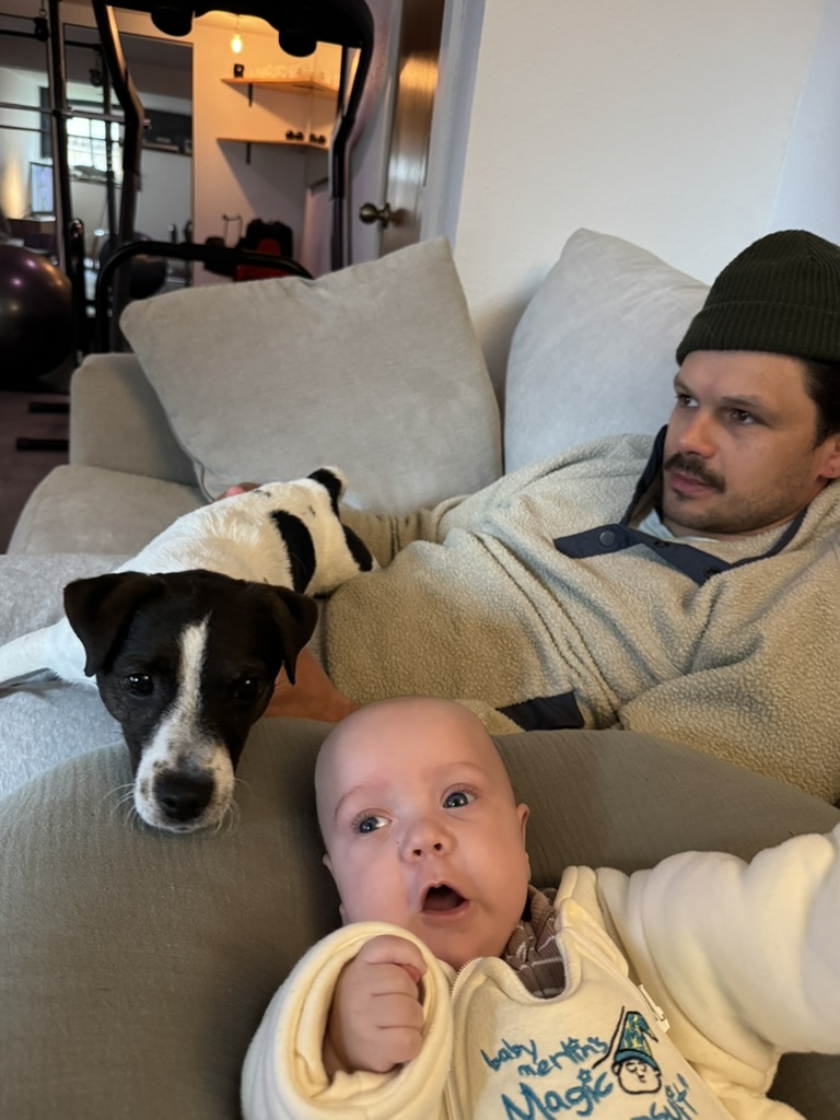 Kylan with a baby and the family dog.